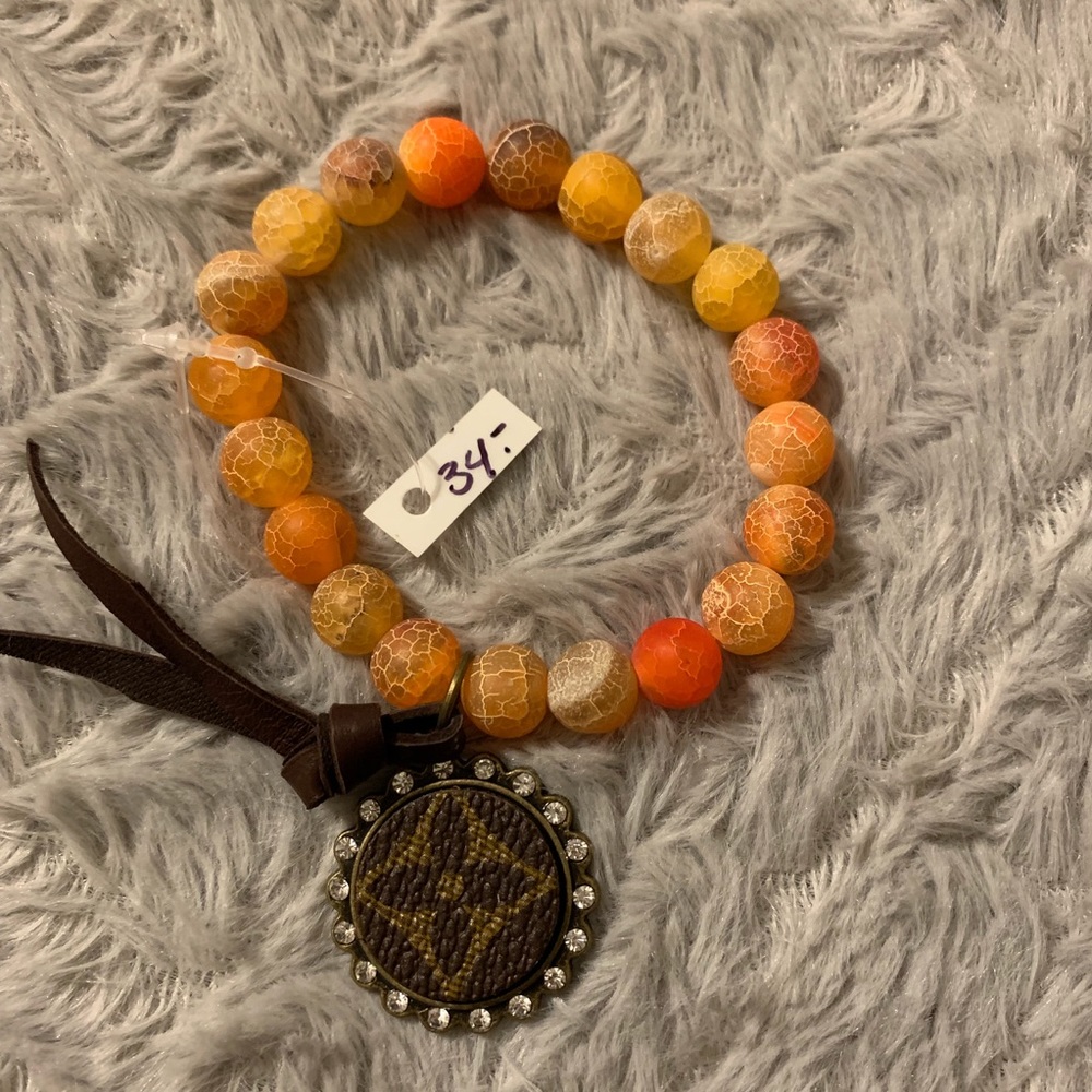 Orange/amber stretch bracelet with Louis charm